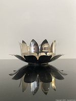 Side view of assembled silver-plated lotus bowl on underplate