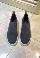 Top view of both sneakers showing knit upper and condition