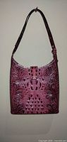 Front view of plum croc-embossed shoulder bag showing strap, body and logo