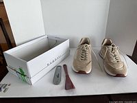 Full lot view with sneakers, shoehorns and box