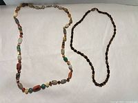 Both necklaces laid flat showing full length and bead variety