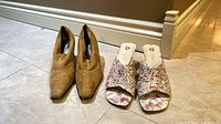 Both pairs of women’s shoes standing side by side on floor