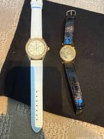 Both wristwatches laid flat for full view