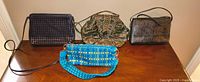 Group image of four handbags in varying colors and materials