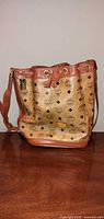 Front view of MCM tan Visetos bucket bag standing upright