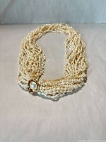 Full view of ten-strand pearl necklace showing clasp and strand arrangement