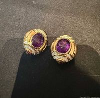 Both earrings front view on black background