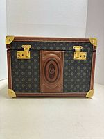 Front view showing Pollini monogram canvas, leather trim, brass latches and corners