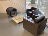 Full set showing three armchairs and coffee table