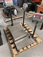 Three Ohaus Defender 3000 platform scales on pallet showing indicators, platforms, cords