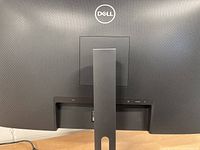 Rear of Dell monitor showing stand, Dell logo, textured back panel