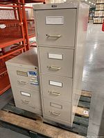 Both filing cabinets on pallet showing fronts and handles