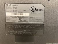 Close-up of specification label showing model, power rating, manufacture date