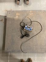 Top view of steel platform scale with indicator and cables