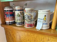 Four beer steins together on shelf