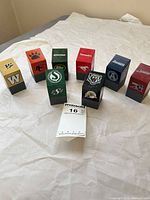 All eight coin banks arranged upright showing front logos