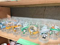 Row of Beijing 2008 Fuwa mascot glasses on shelf