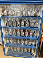 Full view of display case with rows of miniature Stanley Cups