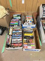 overview of four boxes filled with DVDs and VHS tapes