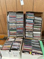 Two stacked boxes and two additional boxes of CDs, showing large quantity
