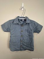 Front view of light blue chambray shirt showing overall design