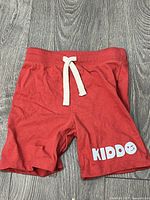 Front view showing red terry shorts, drawstring, and Kiddo graphic