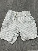 Front view of striped shorts showing waistband, drawstring and pockets