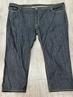 Front view of dark wash Levi's jeans laid flat