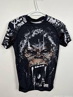 Full front view of Venum gorilla graphic athletic T-shirt on hanger