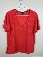 Front view of red V-neck top on hanger