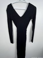 Full view of black ribbed knit V-neck long-sleeve midi dress on hanger