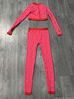 Full view of top and leggings laid flat on floor