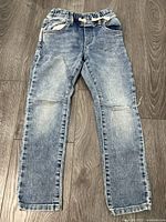 Front view of light-wash denim jeggings showing overall style and condition