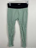 Full front view of sage-green leggings on hanger