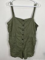 Front view of khaki green H&M Divided romper showing button placket, pockets, straps
