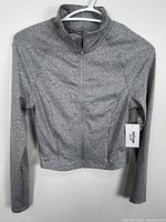 Front view of jacket on hanger showing overall design and condition