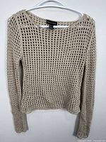 Full view of crochet top on hanger