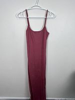 Full front view of burgundy maxi dress on hanger