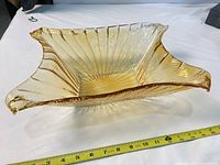 Top view showing rectangular shape, ruffled corners, ribbed texture, tape measure indicating length