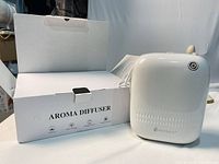 Diffuser standing beside branded box