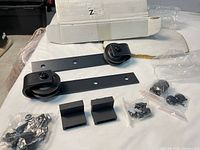 Full contents of barn door hardware kit laid out