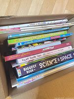 Stack of activity and coloring books in box showing spines and titles