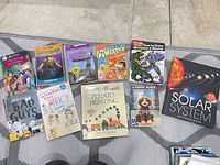 All ten books arranged in two rows on rug