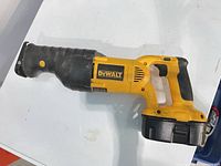 Left side view of DeWALT DC385 reciprocating saw with battery attached