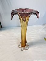 full view of tall pink to amber glass vase with ruffled rim