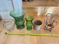 All five items lined up with tape for scale