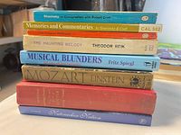 Side view of stacked eight music-related books showing spines and titles