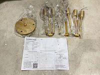 All chandelier components in packaging with canopy and arm rods visible