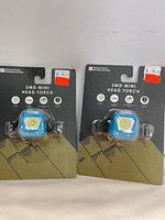 Front view of both packaged head torches