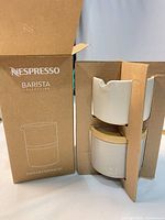 Boxed Nespresso Barista Collection stackable serving set showing packaging and one serving piece with lid